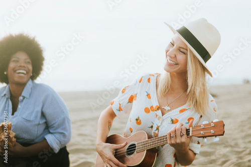 Friends singing together at a beach picnic photo