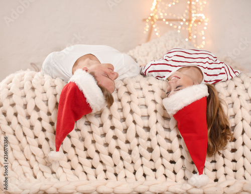 Happy young couple in Santa...