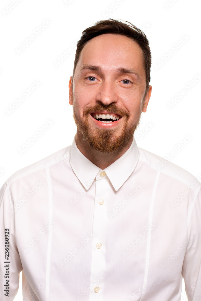 Naklejka premium Stylish bearded business man smiling to camera, having pleased expression and cheerful look.