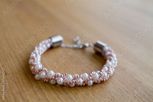 Pearl bracelet on wooden table