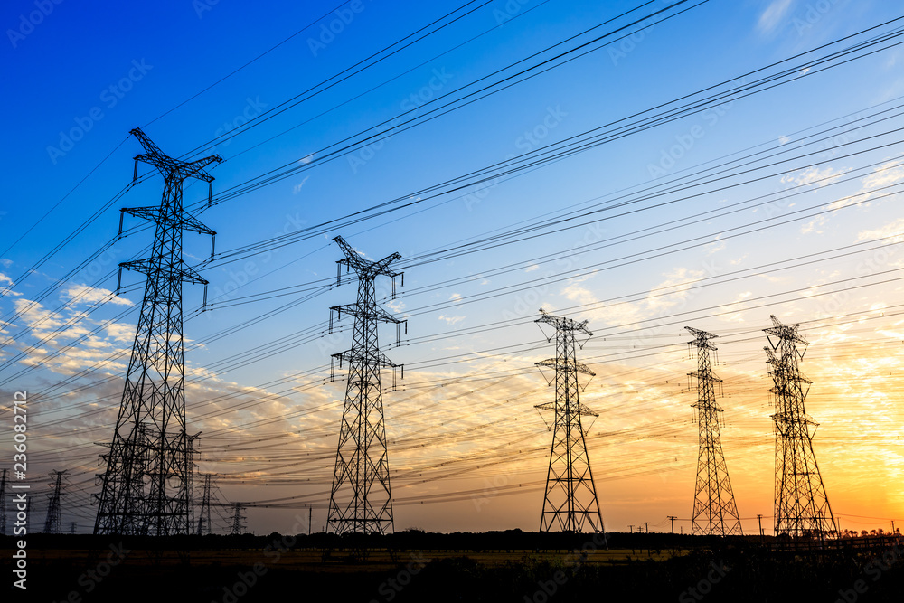 high-voltage power lines at sunset,high voltage electric transmission tower