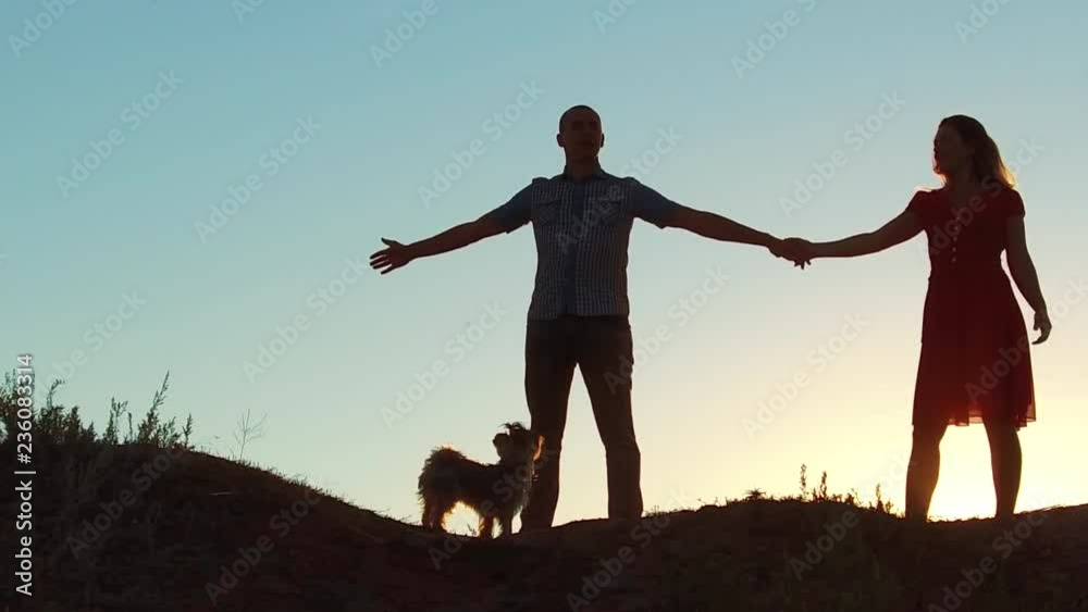 silhouette of a happy young married couple and dog slow dancing outside at sunset. slow motion video. man and girl dancing salsa at sunset. Unidentifiable Silhouette of dancing couple love friendship