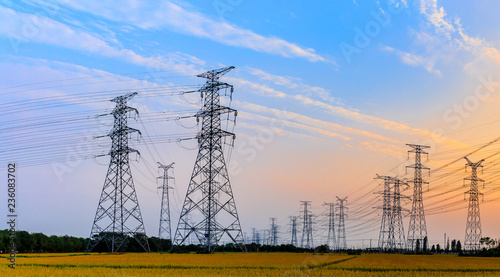 high-voltage power lines at sunset,high voltage electric transmission tower photo