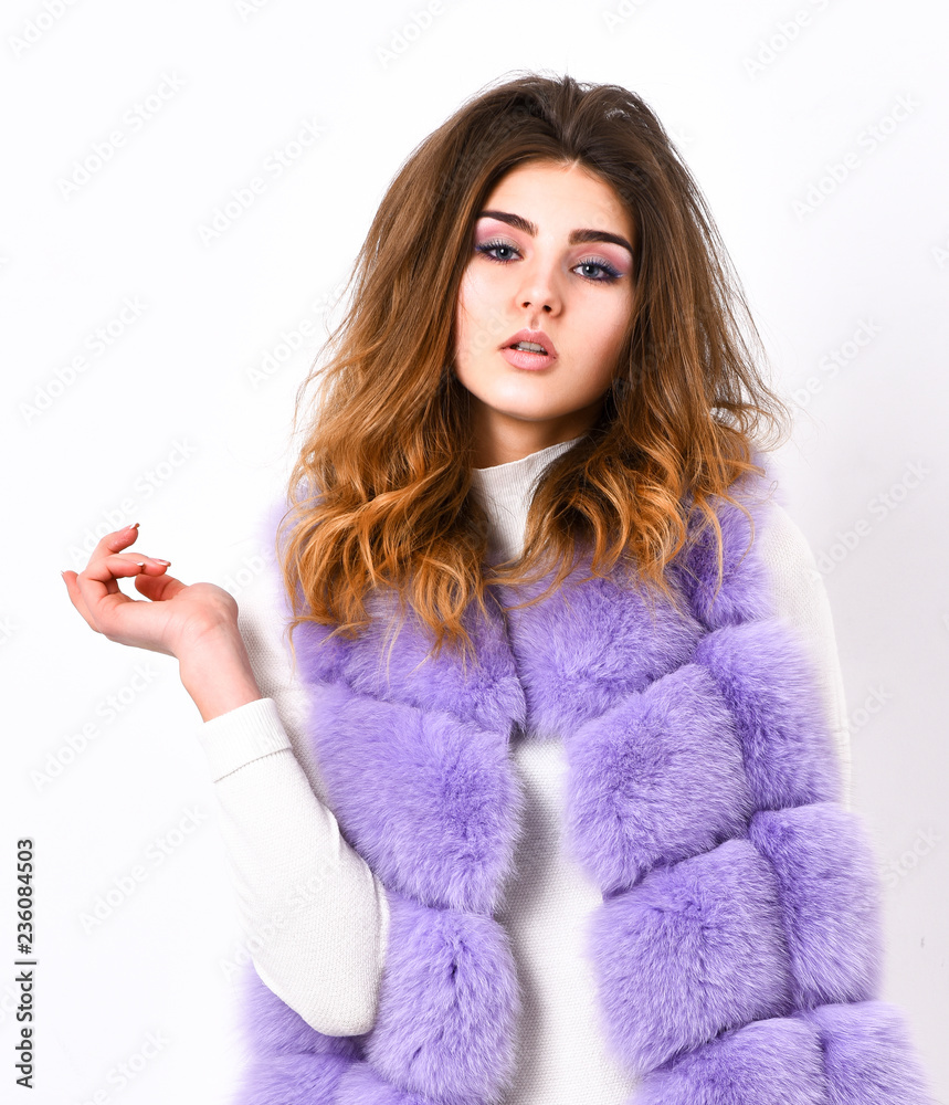 Violet fur vest fashion clothing. Luxury fur clothes for female. Fashion trend concept. Winter fashionable wardrobe for female. Boutique selling fur. Woman makeup face wear fur vest white background Violet fur vest fashion clothing. Luxury fur clothes for female. Fashion trend concept. Winter fashionable wardrobe for female. Boutique selling fur. Woman makeup face wear fur vest white background