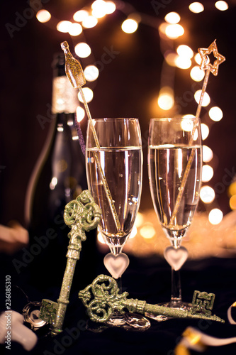 Sylwester, Andrzejki's toast for two. Champagne and fortune telling on a black background. Celebration, lights and new year