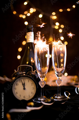 Sylwester, Andrzejki's toast for two. Champagne and fortune telling on a black background. Celebration, lights and new year