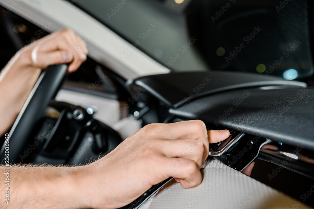 cropped shot of auto mechanic checking automobile