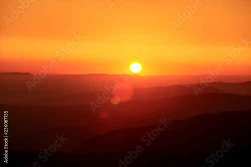 Landscape with mountains and the sun. Sunset. Mountain landscape. Abstract background