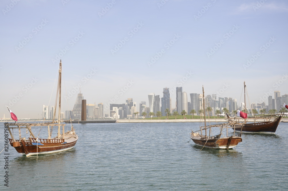 The skyline of the city of future with old boats in the bay