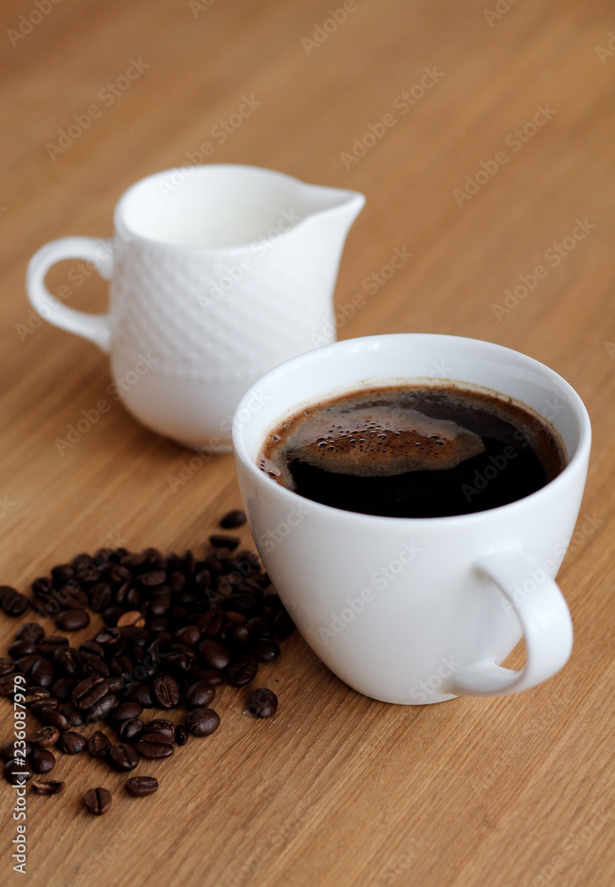 Aromatic fresh coffee in porcelain cup on wooden table Aromatic fresh coffee in porcelain cup on wooden table