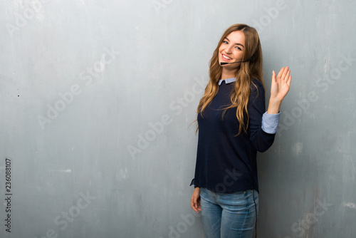 Telemarketer woman saluting with hand with happy expression