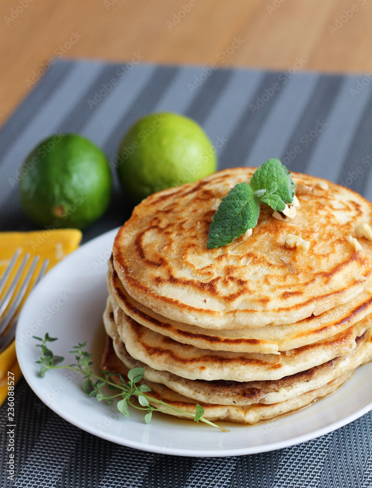 Fresh, delicious pancakes with walnuts on wooden table Fresh, delicious pancakes with walnuts on wooden table
