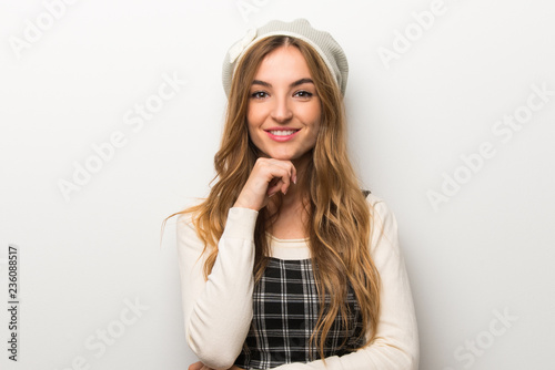 Fashionably woman wearing hat smiling and looking to the front with confident face