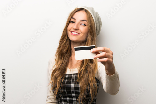 Fashionably woman wearing hat holding a credit card