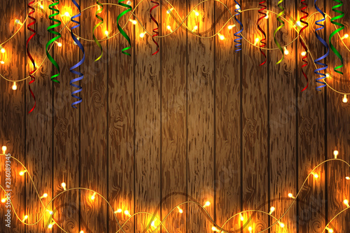 Merry Christmas and happy New year. Christmas garland on a wooden background. Background with copy space.