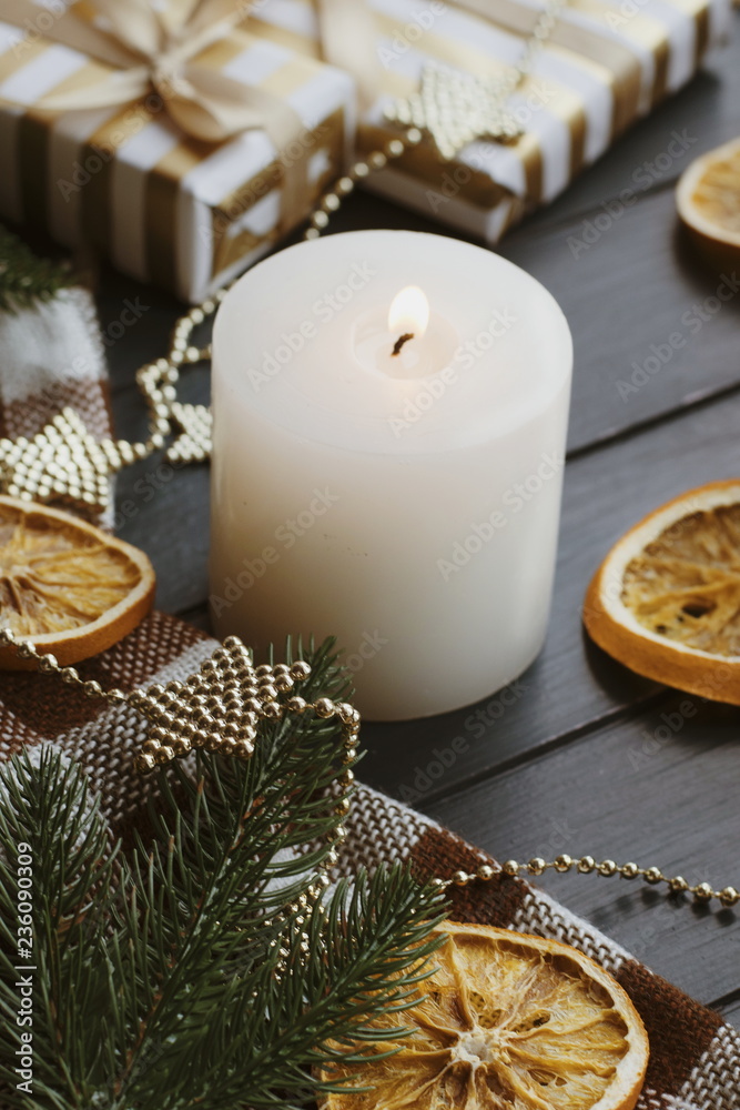 Christmas background with gift boxes oranges burning candle on the table. Golden decor for xmas. Christmas background with gift boxes oranges burning candle on the table. Golden decor for xmas.