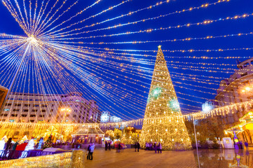 Beautiful Christmas scene with decorated tree outdoor, in Revolution Square, Bucharest - Romania