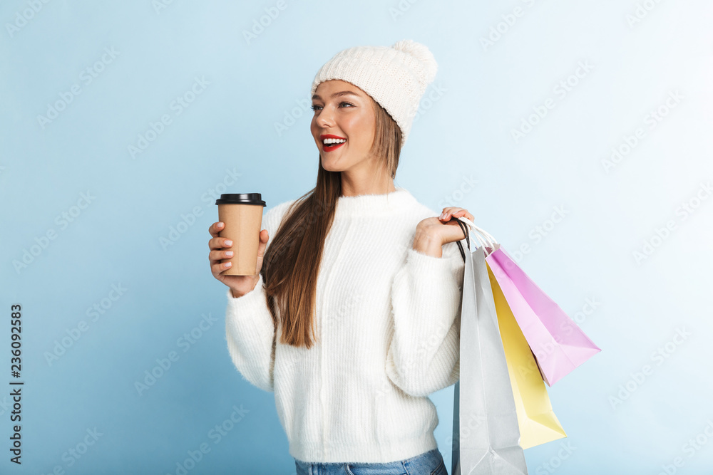 Happy young woman wearing sweater standing