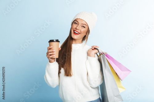 Happy young woman wearing sweater standing