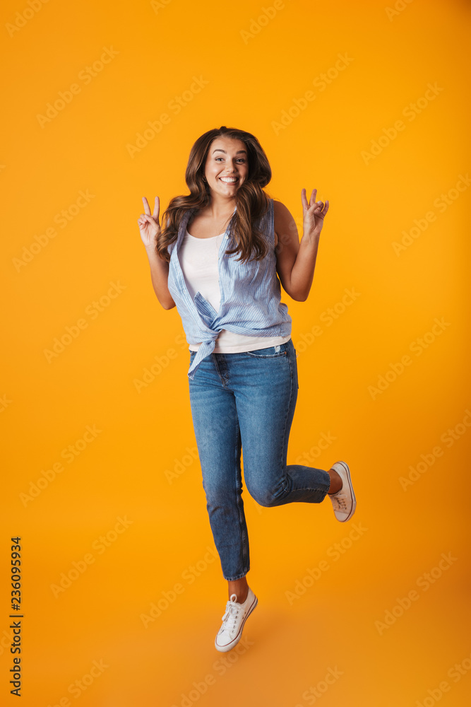 Full length portrait of an excited young casual woman Full length portrait of an excited young casual woman