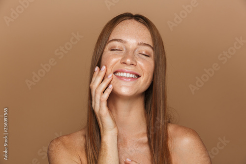 Beauty portrait of a smiling young topless woman