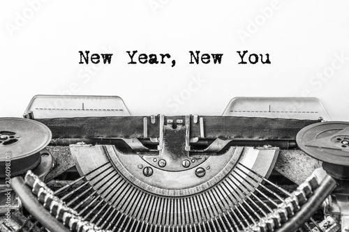 New Year, New You! Text is typed on a vintage typewriter on a white background. Close-up.