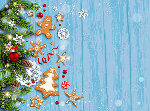 Holiday card with fir tree and festive decorations balls, stars, snowflakes and gingerbreads on wood background.