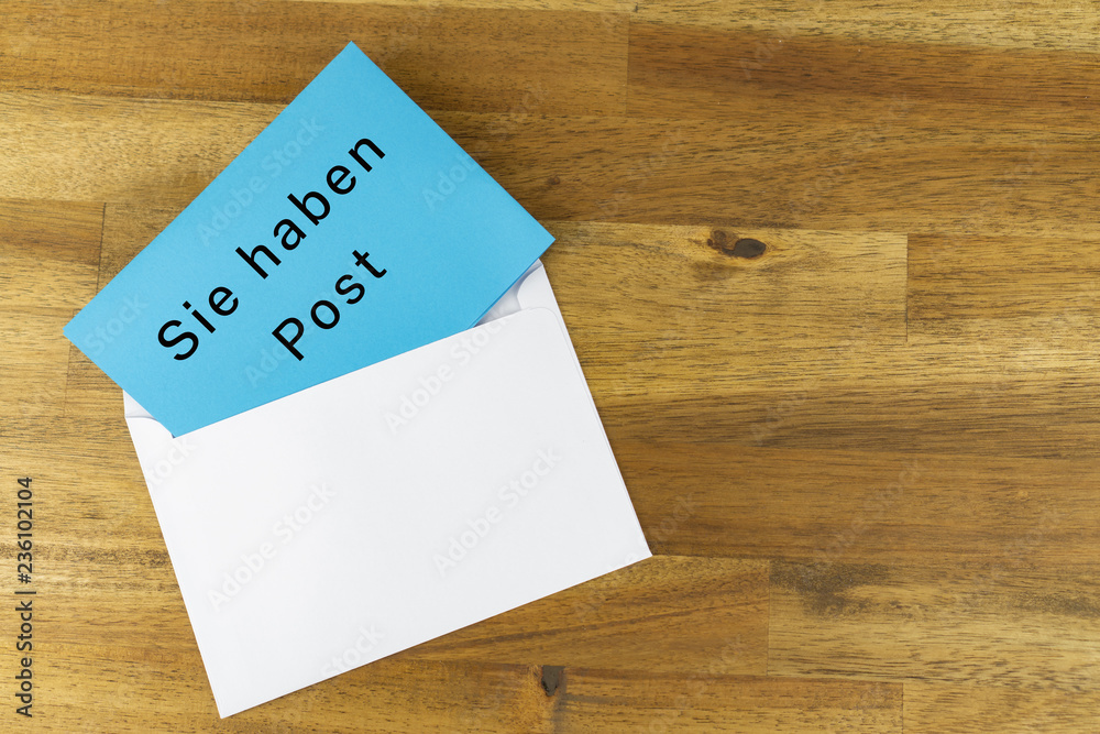 Envelope with a blue note with the german words for you have mail Envelope with a blue note with the german words for you have mail