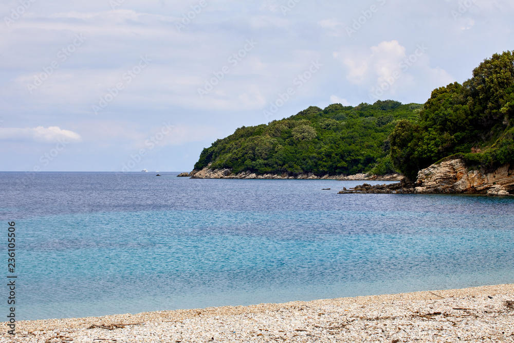 Fototapeta premium Sailing yacht in the Mediterranean. Concept of travel and active lifestyle. Stone beach and warm sea