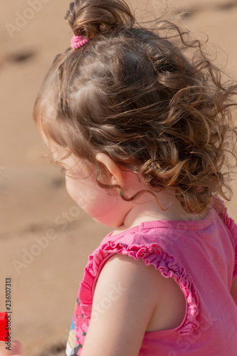 The Side Of A Little Girl At The Beach photo