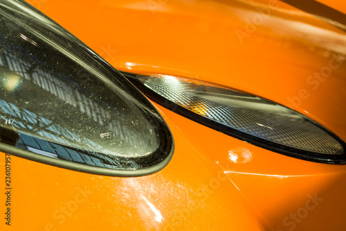 Sports car headlights. Orange Lotus.