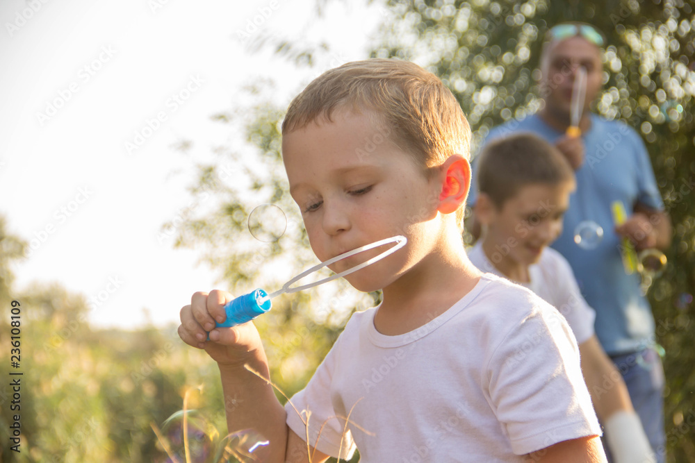 The boy inflates soap bubbles in nature The boy inflates soap bubbles in nature