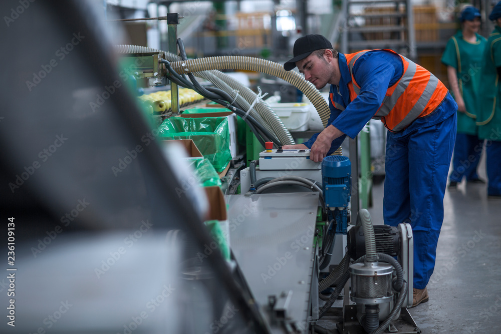 Man working on machine in factory Man working on machine in factory