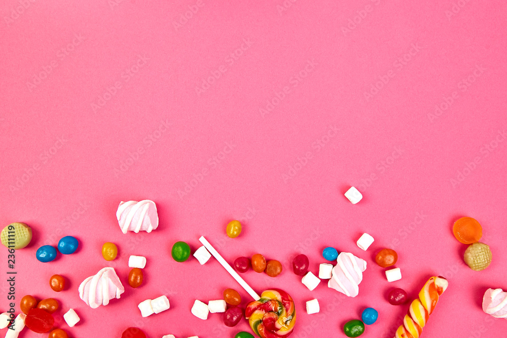 Colorful candies on pink background. Flat lay Colorful candies on pink background. Flat lay