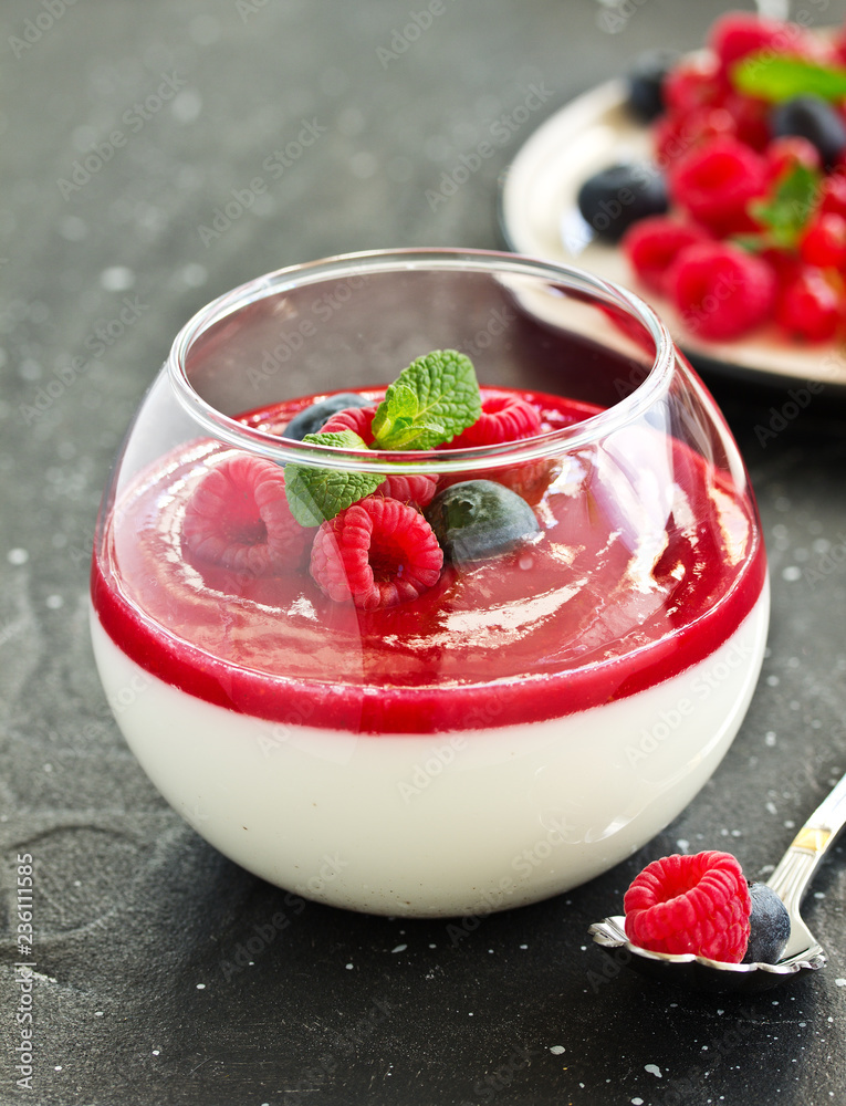 Delicious Italian dessert panna cotta with berries and berry sauce. Valentine's Day.