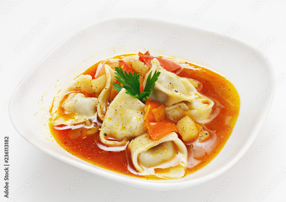 Soup with vegetables and pasta on a white background Soup with vegetables and pasta on a white background