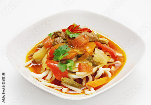 Soup with vegetables and pasta on a white background