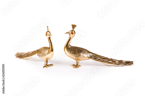 Vintage metal bird figurines on white background © guardalex