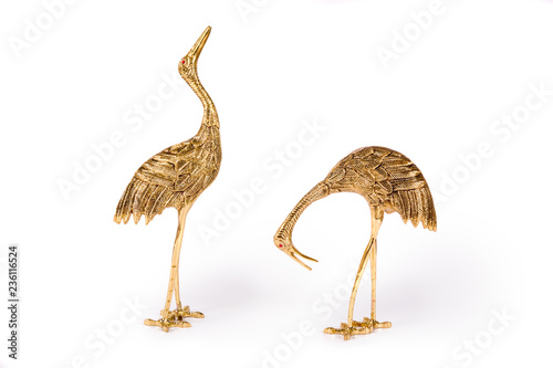 Vintage metal bird figurines on white background