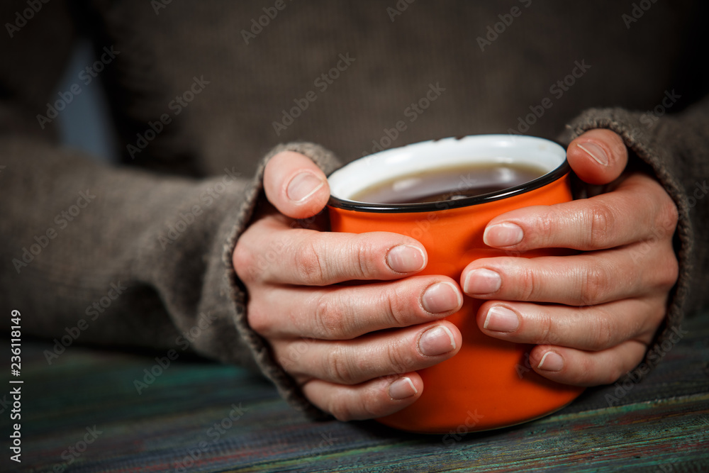Woman holds a cup of hot tea. Cozy morning at home. Woman holds a cup of hot tea. Cozy morning at home.
