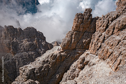 Mountaineers equipped face the "Bocchette Alte" ferrata in the Brenta group on the Dolomites, in Italy