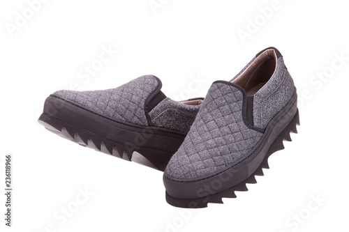 Shoes from gray textiles. Walking shoes. A pair of trendy gray textile shoes.