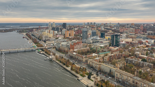 Drone's eye view of Dnipro city downtown on coast of Dnieper river. Fly over cityscape with buildings.