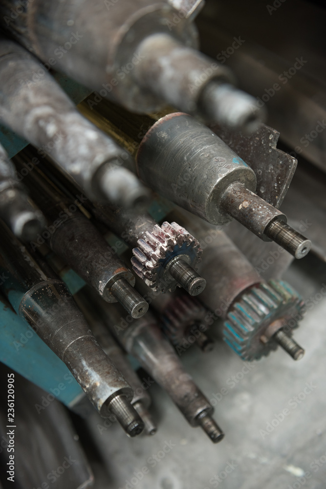 Beautiful metal industrial machinery steel cogs in a rustic industrial factory setting. Well used processing machinery parts. Beautiful metal industrial machinery steel cogs in a rustic industrial factory setting. Well used processing machinery parts.