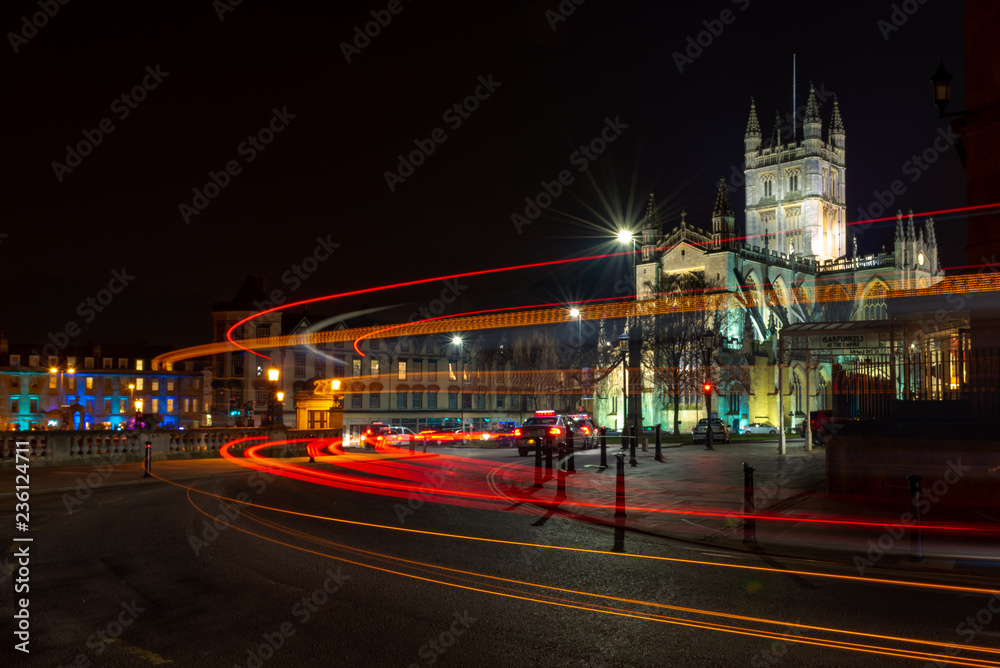 Bath Catherdral illuminated at night with light trails from moving vehicles