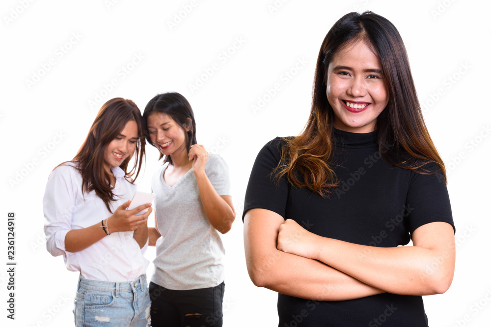 Young happy Asian woman smiling with arms crossed with two happy Young happy Asian woman smiling with arms crossed with two happy