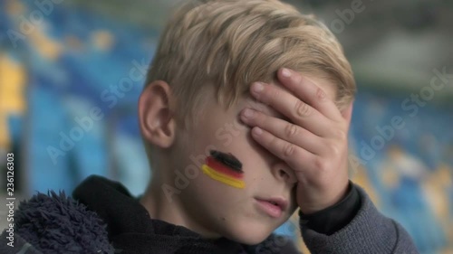 Young german fan upset after match loss, football championship, team support photo