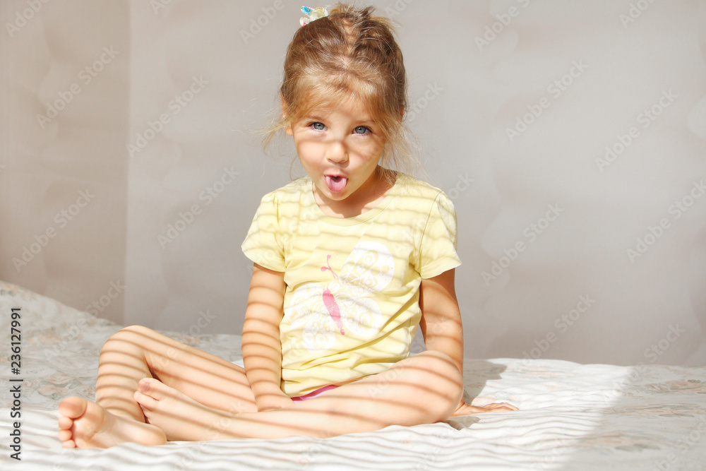 Fototapeta premium Portrait of a cute girl showing tongue in the morning. Joke