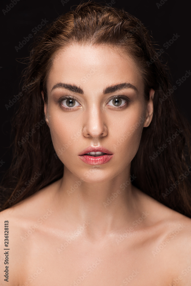 portrait of attractive young woman with brunette hair, isolated on black