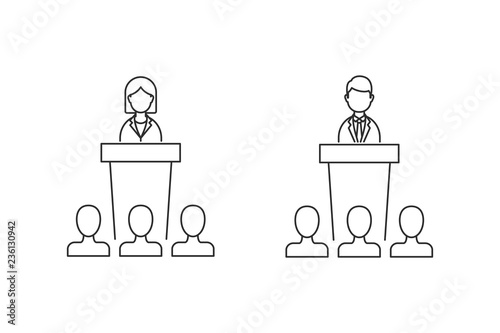 A woman and a man speaking from a rostrum